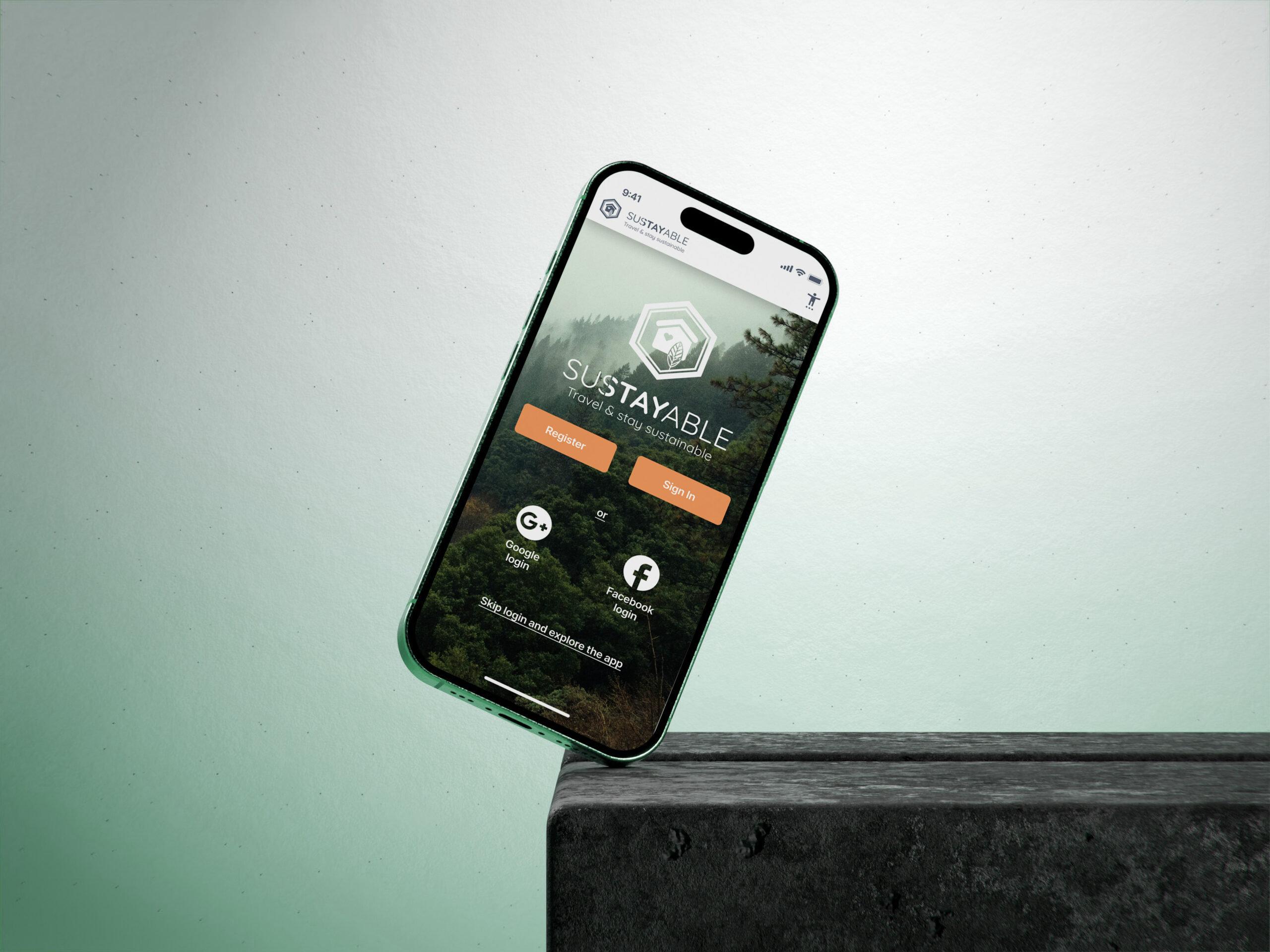iPhone balancing on green background showing the Sustayable app login screen.
