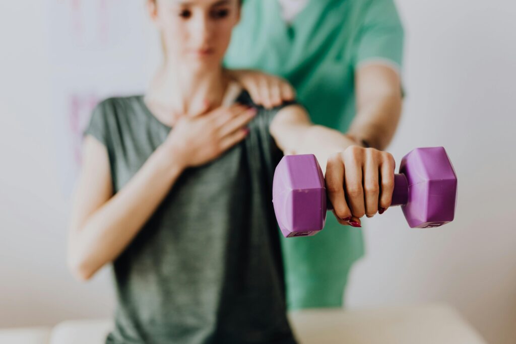 Woman holding a weight exercising her shoulder.